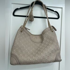 Light tan almost blush Tory Burch shoulder bag with gold chain hardware.  Used.